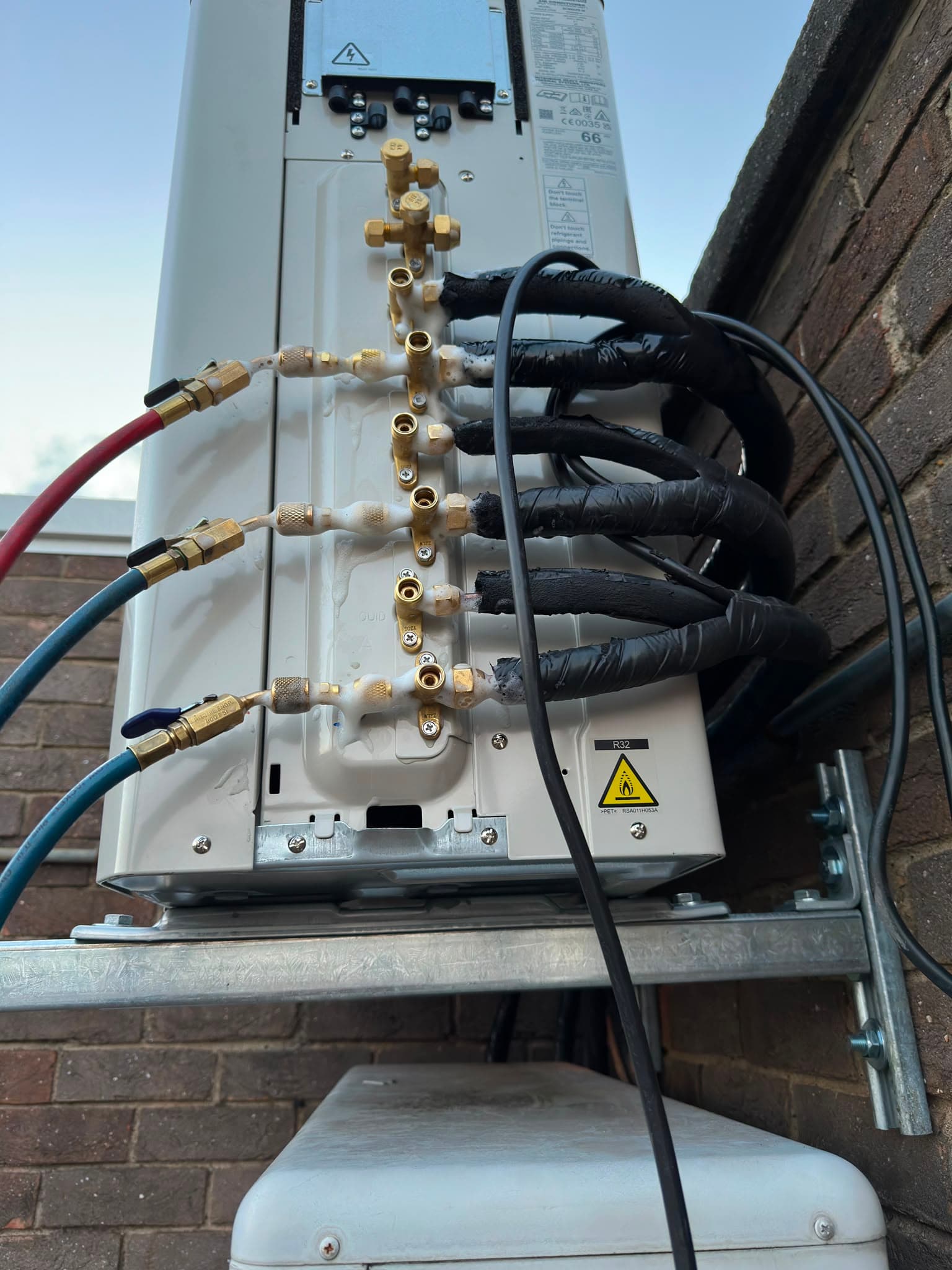 HVAC engineer fitting an air conditioning unit in a London home